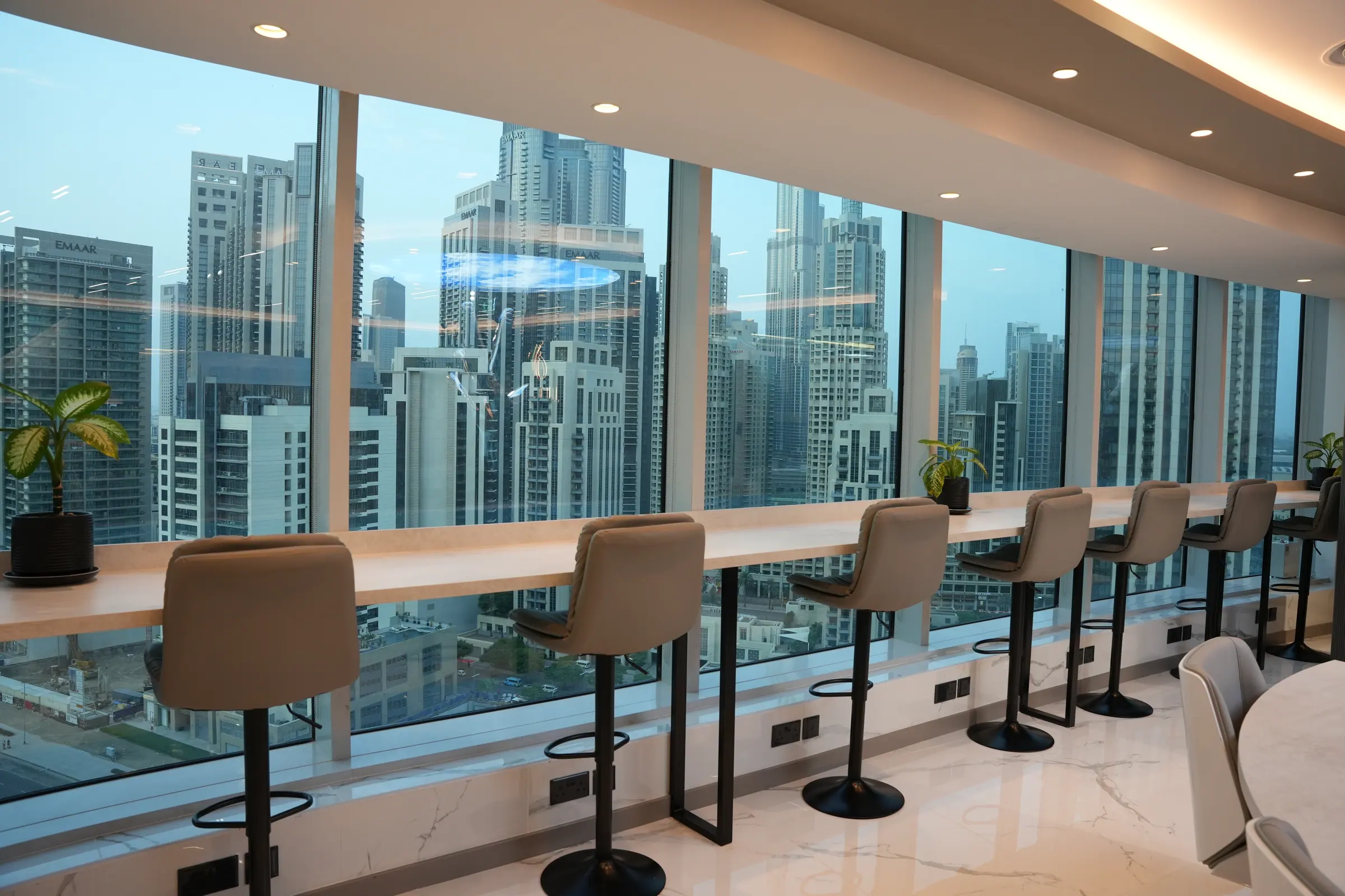 Coworking seats along the floor-to-ceiling windows of the 20th floor